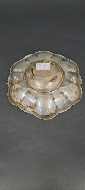 null Silver bowl resting on three feet with leafy attachments, scalloped and twisted...