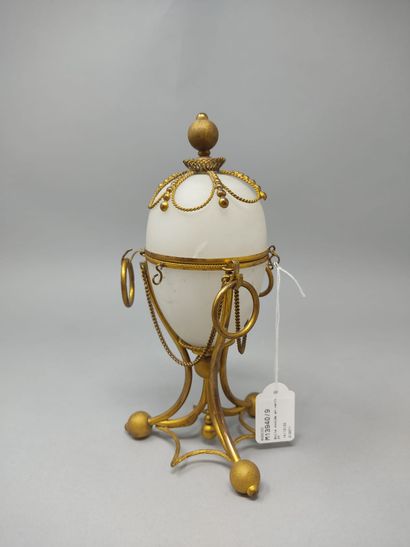 null Opaline glass ovoid box, gilded metal frame resting on three feet balls joined...