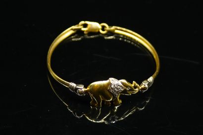 null Rigid bracelet in yellow gold 18k (750) holding an elephant adorned with small...