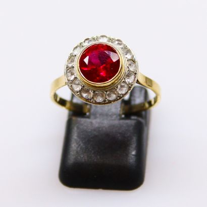 null 18k (750) yellow and white gold ring set with a synthetic ruby in a circle of...