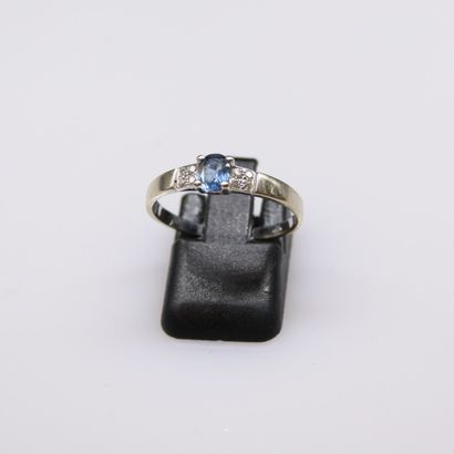 null 9k (375) white gold ring set with a small sapphire and diamond chips.
Finger...