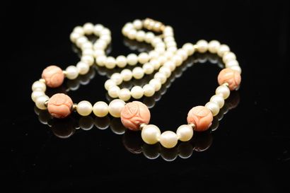 null Necklace of cultured pearls, adorned with engraved coral balls and gold ferrules,...