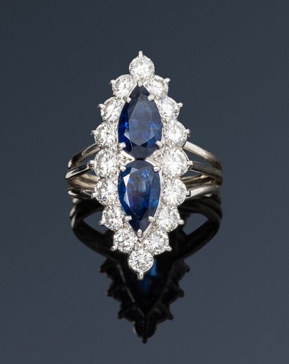 null Platinum and 18K (750) white gold marquise ring, set with two drop-cut sapphires...