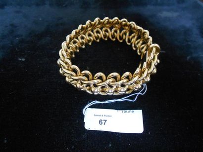 null Bracelet articulé à décor d'entrelacs en or jaune. Vers 1950. Poids: 45 g. Longueur:...