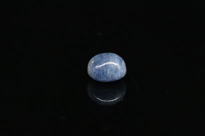 null Blue sapphire cabochon on paper. 

Weight : 10.92 cts.