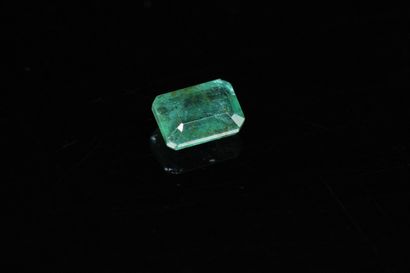 Rectangular emerald with cut sides on paper....
