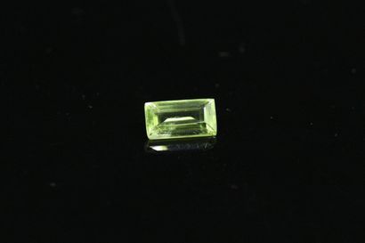 Rectangular peridot with sharp sides on paper....