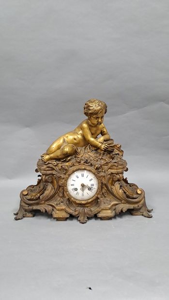 null Patinated and gilt bronze clock representing a child lying on a mound playing...
