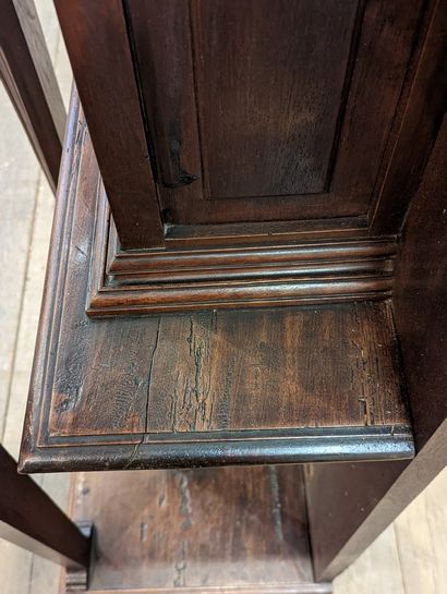 null Cabinet in credenza in walnut and resinous wood, opening with a carved ventaux...