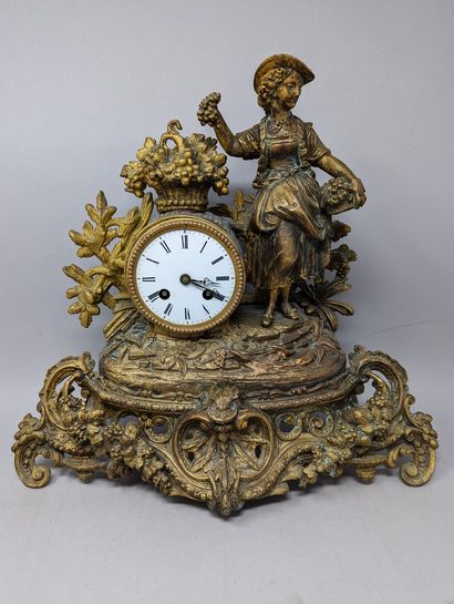 null Clock in gilded regule with decoration of a young grape picker, a basket of...