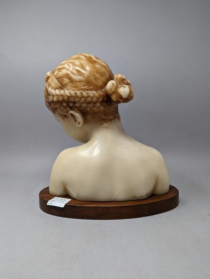 null Bust of a smiling girl with her head tilted to the left, wax print, on an oval...