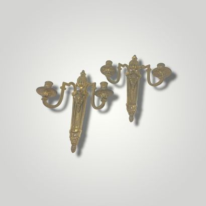 null Pair of two arms sconces in gilt bronze and chased with flutes and decorated...