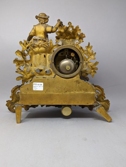 null Clock in gilded regule with decoration of a young grape picker, a basket of...