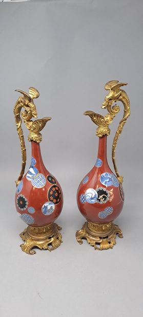 null Pair of Japanese porcelain bottle vases with long tapered necks, red background...