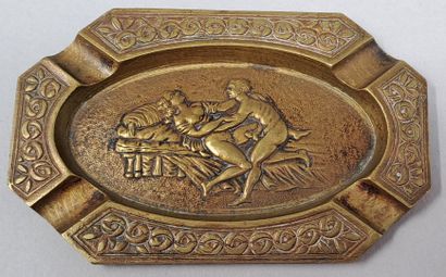 null CURIOSA
Octagonal ashtray in brass representing a couple in frolic on a bed,...