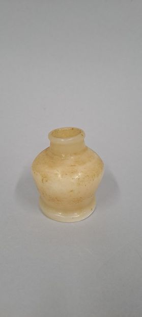 null Small cosmetic vase with globular body and discoid foot.
Alabaster, neck cut...