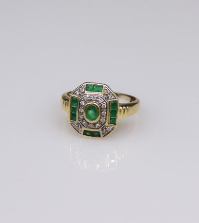null 18k (750) yellow and white gold ring set with emeralds and diamonds. 
Circa...