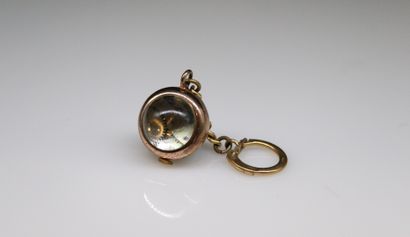 null Watch in the shape of a golden metal ball forming a key-ring, golden stick index...