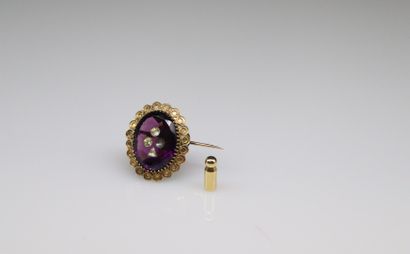 null Gilded metal brooch decorated with a violet stone and white stones stylizing...