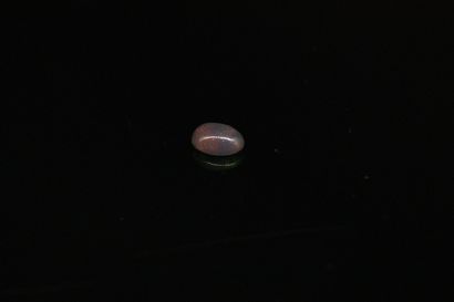 null Black cabochon opal on paper. 
Weight : 0.96 ct. 

Dimensions: 8.3mm x 6mm