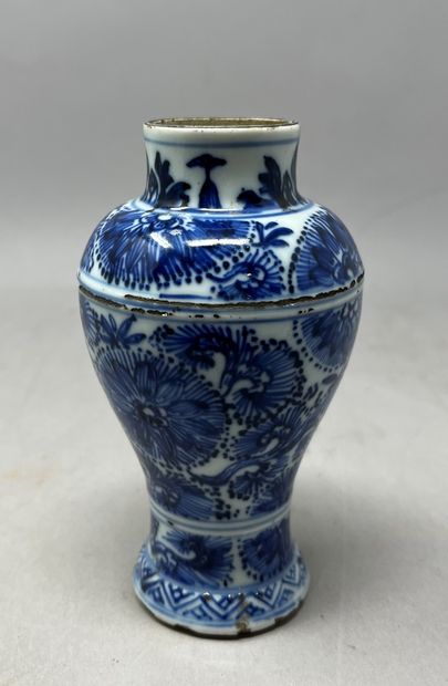null CHINE - XXème siècle.
Petit vase balustre à décor blanc bleu de fleurs.
Egrenure...