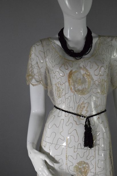 null ANONYMOUS 
Circa 1925

Cocktail dress in transparent muslin embroidered with...