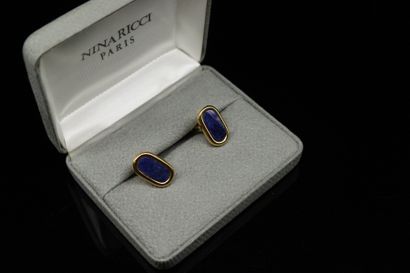 null NINA RICCI 

Pair of gilded metal buttons encircling a blue hardstone cabochon....