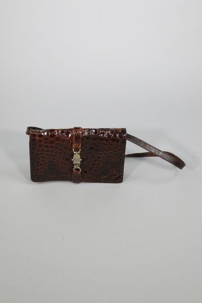 null CELINE

Small brown leather bag reptile style with central clasp numbered C...