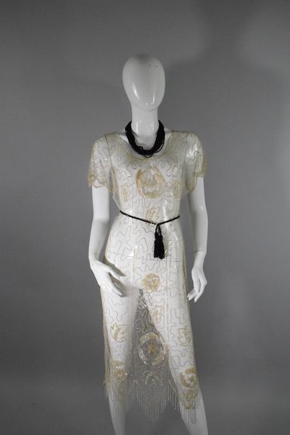 null ANONYMOUS 
Circa 1925

Cocktail dress in transparent muslin embroidered with...