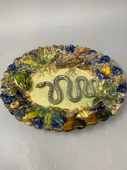 null Enameled earthenware dish with molded relief decoration representing a snake,...