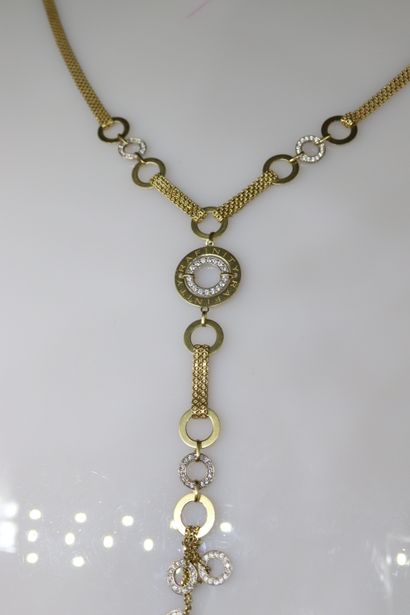 null Ribbon necklace in 18K (750) gold, punctuated with rings set with white glass...