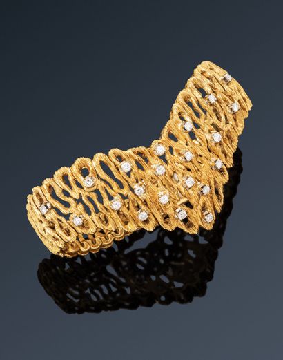 null Case of Madame X, Greece.
Textured 18K (750) gold lace bracelet, pierced with...