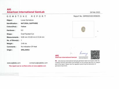 null Pale yellow oval sapphire on paper.

Accompanied by an AIG certificate attesting...