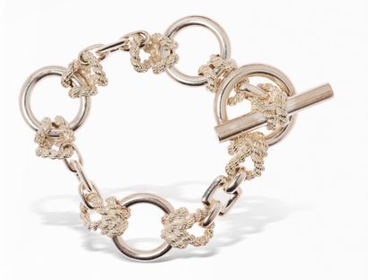null HERMÈS
Silver bracelet, articulated rings connected by cords and square links....