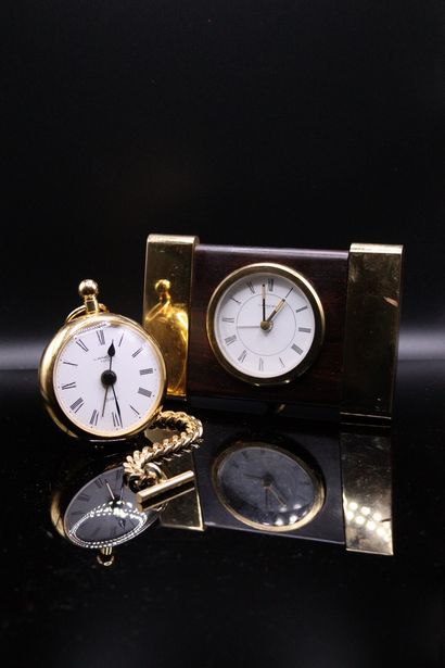 null LANCEL 

Lot of two gilded metal alarm clocks.
One featuring a figurative pocket...