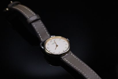 null HERMES PARIS 

Lady's watch "Arceau" model in steel and gilded metal. 
Quartz...