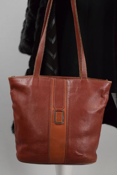null COURREGES 
Circa late 1970

Mahogany grained leather bucket bag with a rectangular...