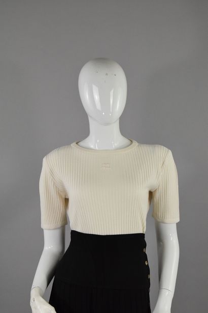 null COURREGES 
Circa late 1970

Short-sleeved top in white knitwear, signed on the...