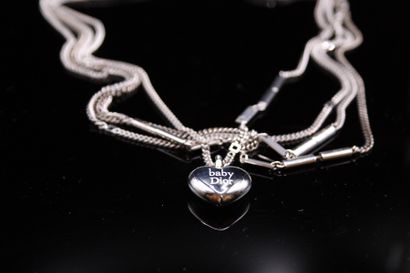 null CHRISTIAN DIOR 

Lot composed of 4 silver plated metal necklaces, one holding...