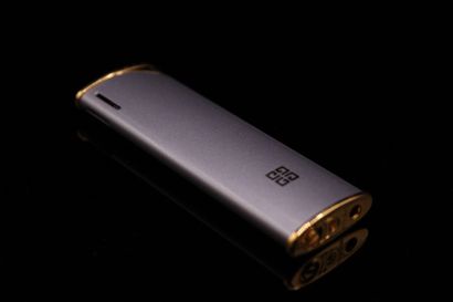 null GIVENCHY 
Circa 1980

Lighter in gilded metal and purple chrome. 
With original...