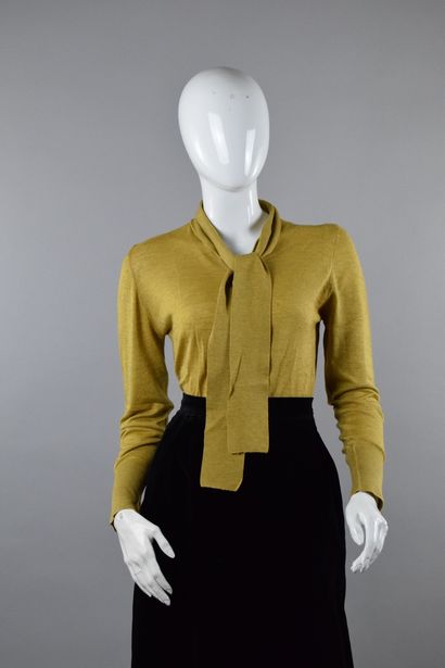 null TED LAPIDUS Haute Boutique
Circa 1980

Ash yellow fluid knit sweater, tied at...
