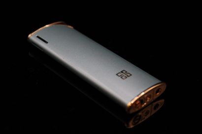 null GIVENCHY 
Circa 1980

Lighter in gilded metal and turquoise chrome. 
With original...
