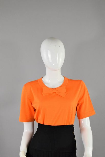null CHANEL Boutique 
Probably Spring/Summer 1995

Tangerine knit top with short...