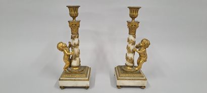 null Pair of candlesticks in marble and gilt bronze, the square base resting on four...