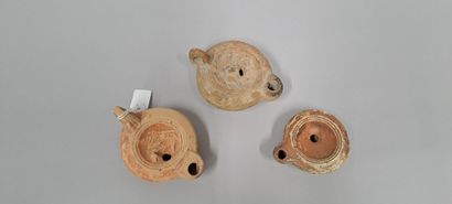 null Lot of three oil lamps, two with round spout and straight line, and one with...