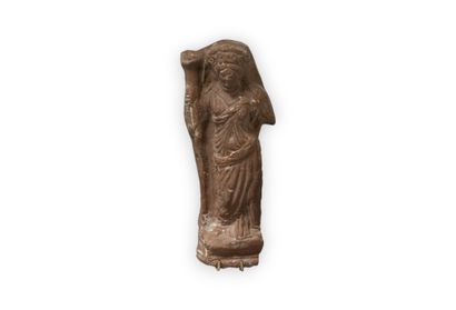 Cast statuette representing a standing deity,...
