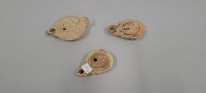 null Lot of three oil lamps, two of them with scroll spouts and one with a round...