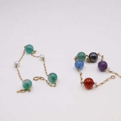null Lot of two 18k (750) yellow gold bracelets, each adorned with balls of colored...
