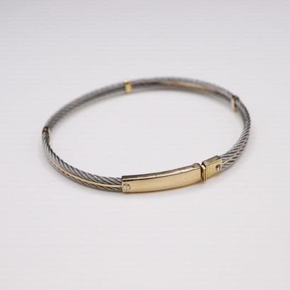 null Steel and 18K (750) yellow gold bracelet. 
In the Fred style. 
Diameter : approx....