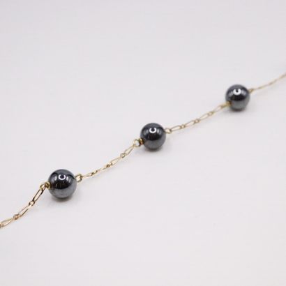 null Bracelet in 18k (750) yellow gold and balls of black stones.

Wrist size : 20...